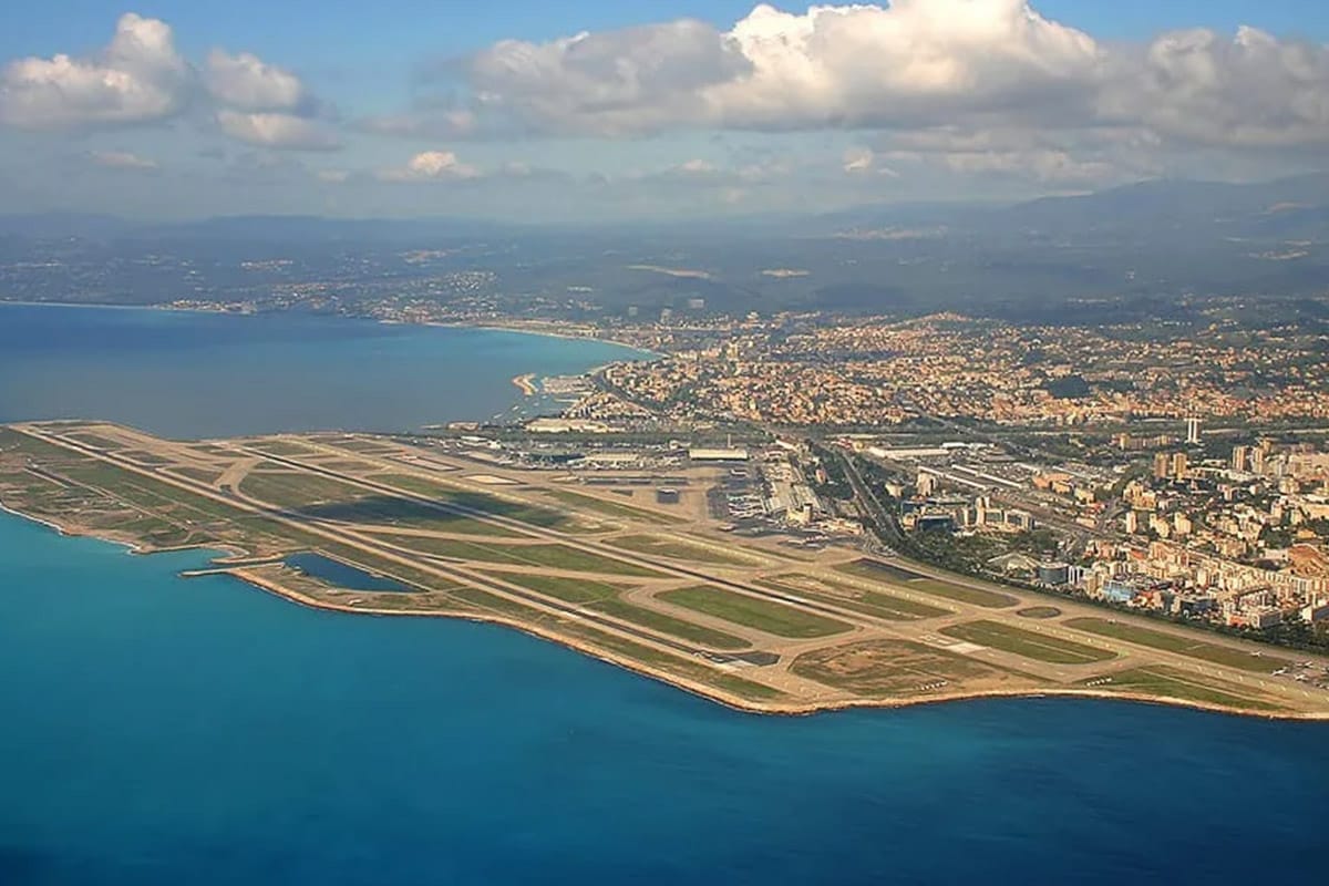 airport-transfer-service-french-riviera-brid view-07 Aerial view of Nice Airport with runways by the sea and cityscape