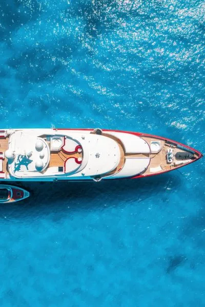 Aerial view of a luxury yacht cruising in the turquoise waters of the French Riviera – private boat charter service.