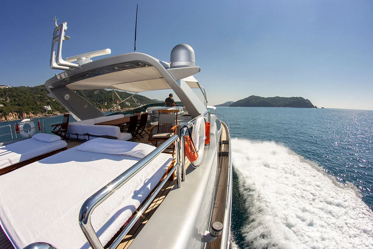 boat-charter-service-french-riviera-yacht-deck-cruise-view Sunny day on a luxury yacht deck cruising along the French Riviera coastline with scenic views.