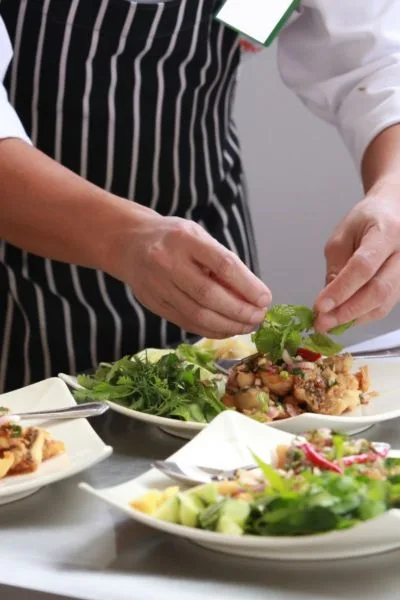 Private chef preparing gourmet dishes for villa guests on the French Riviera – fine dining experience.
