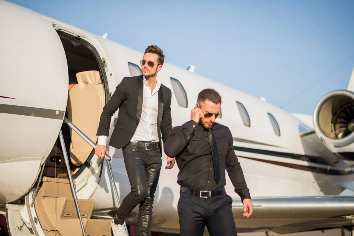 Professional bodyguard escorting VIP client during private jet arrival on the French Riviera