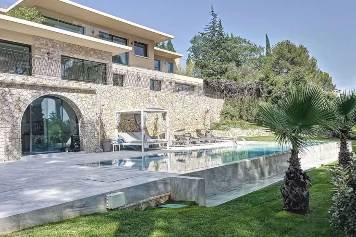 villa-caroline-mougins-for-rent-exterior-view-poolside Villa Caroline in Mougins French Riviera rental with stone facade, elegant infinity pool, sun loungers, and lush garden views.