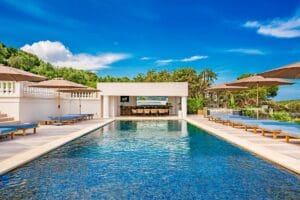 Covered outdoor bar and dining cabana next to the pool at Villa Diana Mougins with surrounding lounge zones