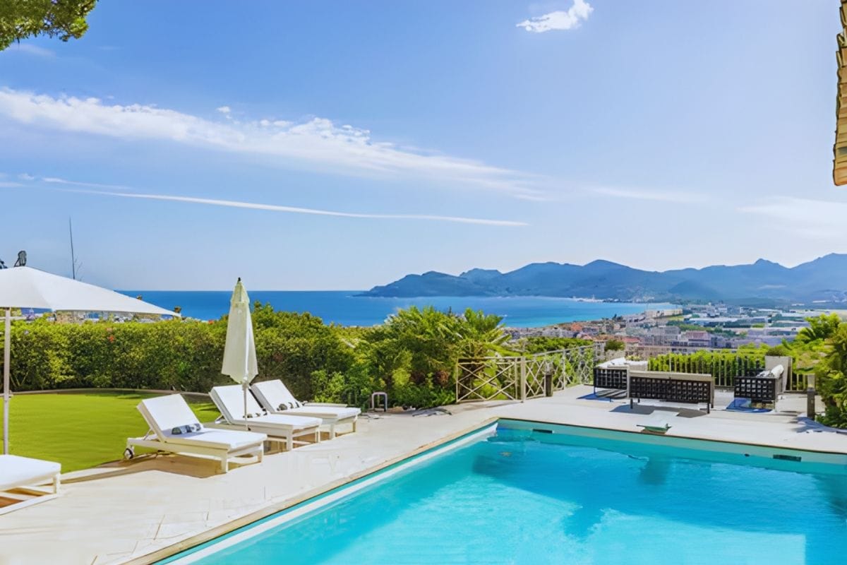 Swimming pool with sun loungers and sweeping sea views overlooking Cannes at Villa Ciel Bleu