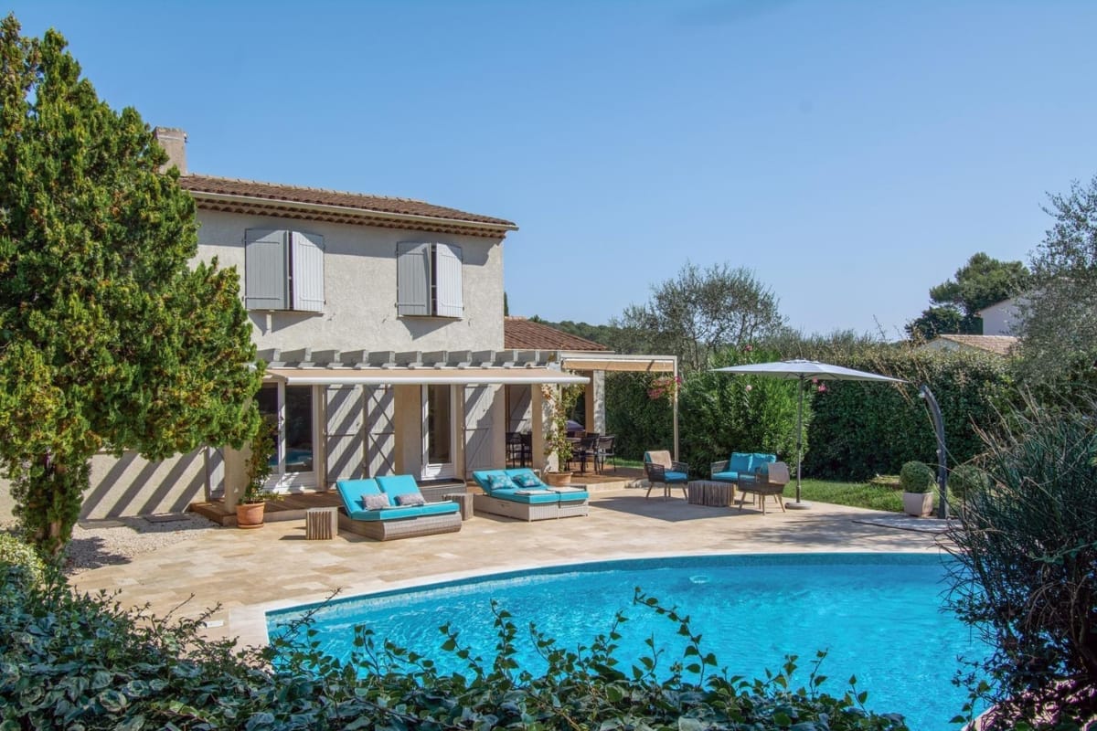 Wide aerial view of the estate showing Villa White House, its' pool area, landscaped gardens and tennis court with Mediterranean scenery.