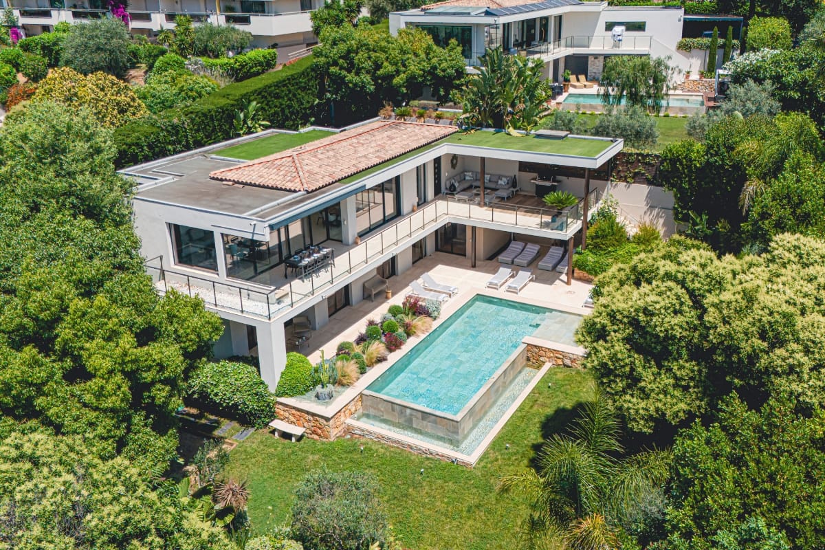 Aerial exterior view of Villa Palméa with infinity pool, landscaped garden, and terraces in Cannes, French Riviera